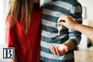 Couple receiving house keys at a New Jersey real estate closing