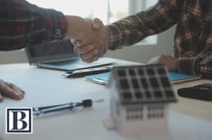 Buyer and seller shaking hands over a solar agreement at a real estate closing